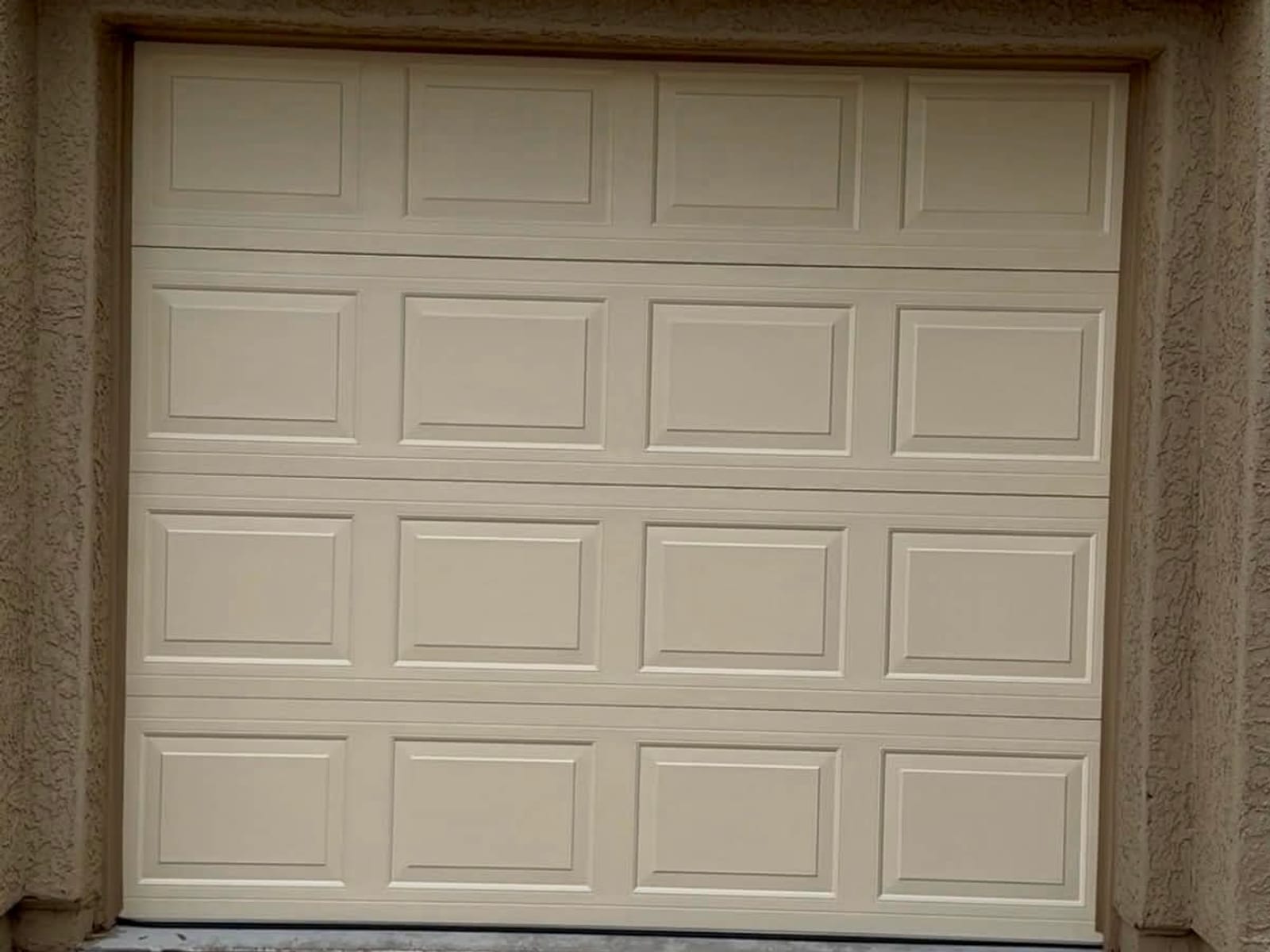 After: new insulated raised-panel garage door, closed, in the same opening in Mesa